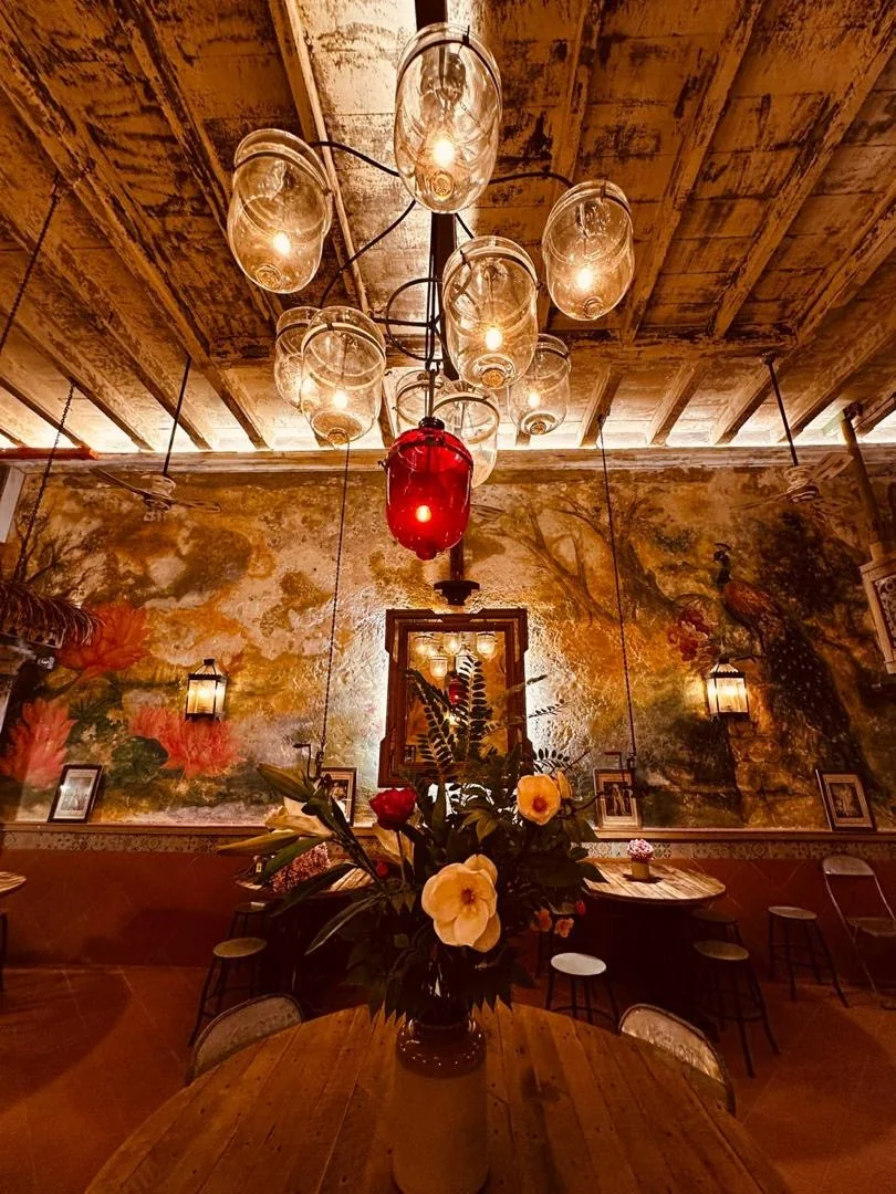 Ornate glass chandelier with a red lamp glowing above the Nagarathar heritage room