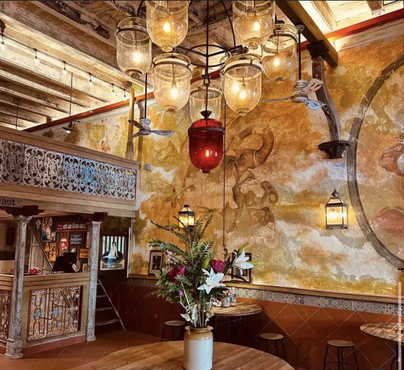 The Heritage Gallery interior — vintage glass lanterns and hand-painted murals