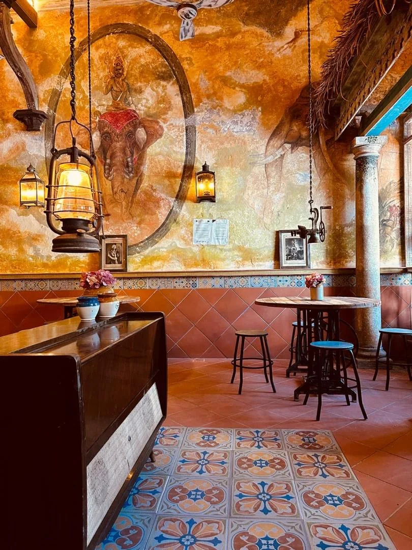 Inside the IHCC gallery — hand-painted elephant mural, vintage lanterns and patterned heritage tiles